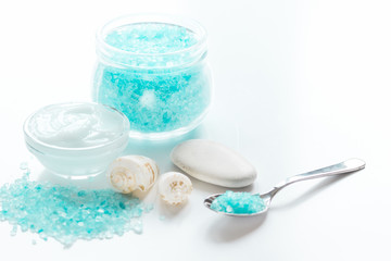 Fototapeta na wymiar blue sea salt and body cream on white desk background