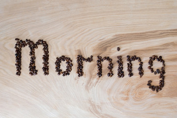 Word morning laid out from coffee grains on a wooden background