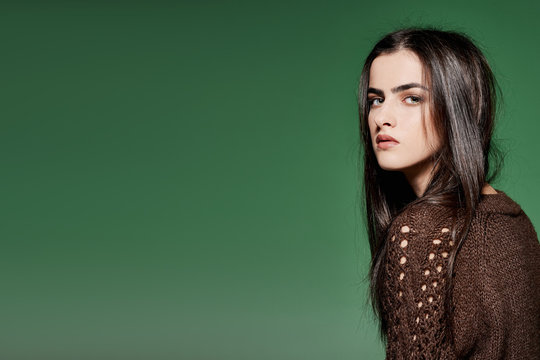 Girl beauty studio portrait on green background