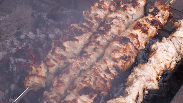 Cooking kebab on the coals. Grilled pork on skewers. Footage clip 4K, UHG, Ultra HD