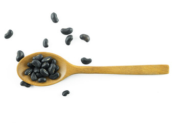 Black beans in the wood spoon isolated on white background., This has clipping path.