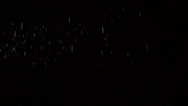 Some dust of liquid particles flowing on dark background