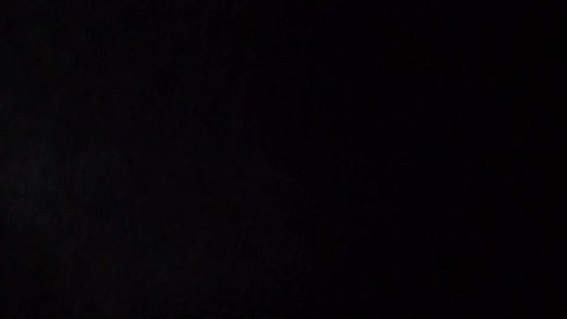 Some dust of liquid particles flowing on dark background