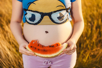 Smile. Pregnant woman with watermelon in hands