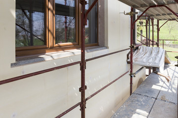Installation of outer coat insulation on a residential building