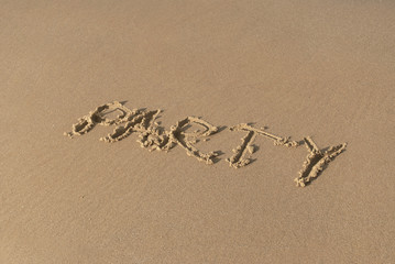 Party message on the beach sand. sunny day