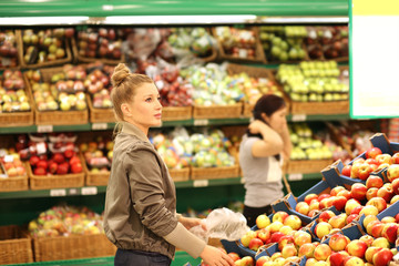 Middle-age woman buying vegetables at the market