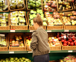 Middle-age woman buying vegetables at the market