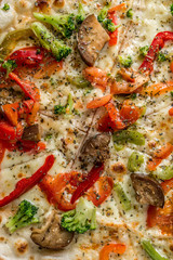 Hot steaming pizza with vegetables, closeup, topview