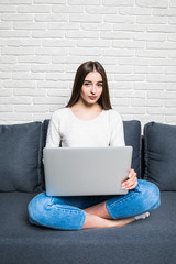 young beautiful woman using a laptop computer at home