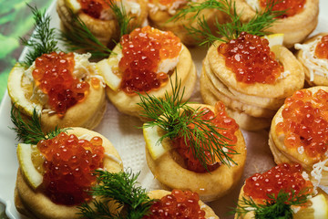 Tartlet with red caviar,Tartlet with red caviar close up. Snacks with red caviar, gourmet food, appetizer,The tartlets filling of mascarpone