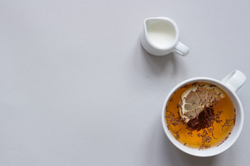 Tea background. Cup of hot black tea on the blue background, top view. Copy space