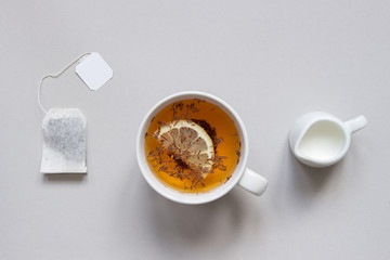 Tea time. Cup of hot black tea on the blue background, top view