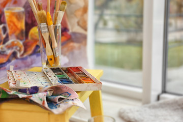 Set of materials for painting on blurred background, close up view
