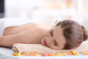 Fototapeta na wymiar Young beautiful woman relaxing in spa salon