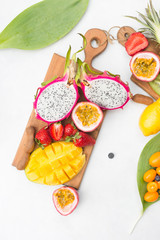 Exotic fruits. Summer photo concept. Mango. Papaya. A pineapple. Avocado. Kiwi. Exotic fruits. Mango. Papaya. A pineapple.  Kiwi. Pitahaya. Kumhvat. Copyspase. Fresh fruits