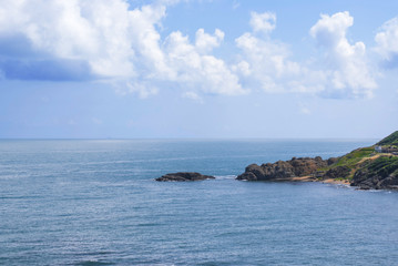 Rocky coastline and cloudy blue sky
