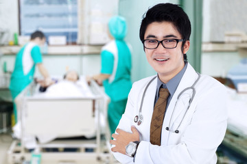 Male doctor smiling at patient room