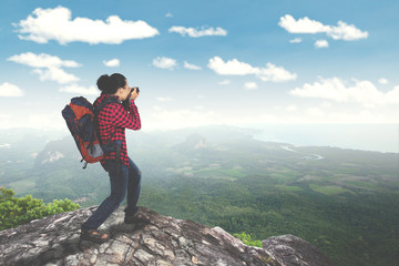 Male traveler taking photo on mountain