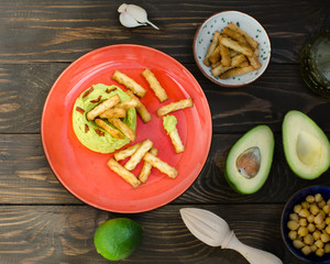 Avocado Hummus with mini grissini, rustic still life