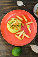Avocado Hummus with mini grissini, rustic still life