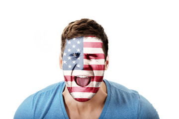 Screaming man with USA flag on face.