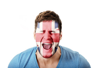 Screaming man with Great Britain flag on face.