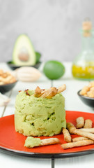 Avocado Hummus with mini grissini, rustic still life