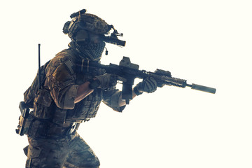 Army Ranger in field Uniforms with weapon, plate carrier and combat helmet are on, his face closed...