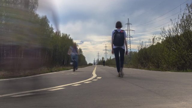 Time Lapse Video Of Cyclists And Skaters Rolling Through The Alley Of The City Park In Early Spring