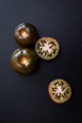 Black tomatoes on black background