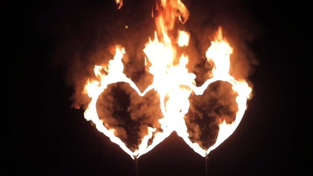 two burning heart on a dark background at night on the street 