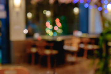 Abstract blurred Shabu and BBQ restaurant interior with empty table sets and light bokeh.