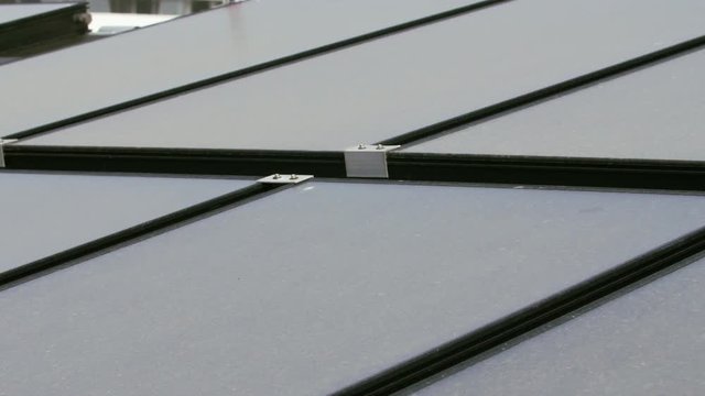 Solar collector panels rooftop close up with blurry building background
