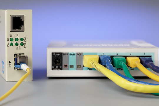 Media converter with optical patchcord and router connected via copper cable