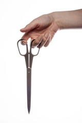 woman hand hold a scissors isolated white.
