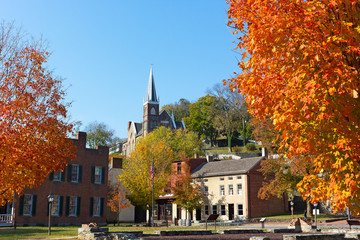 Harpers Ferry historic town in autumn, West Virginia, USA. The town in magnificent fall colors with historic site and city church.