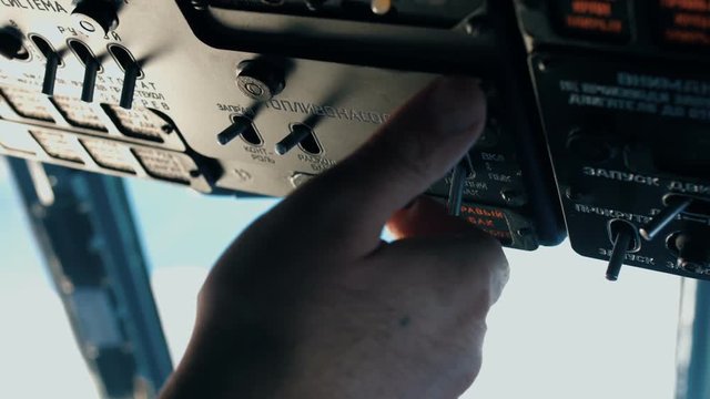 The pilot of the helicopter is preparing for the flight.