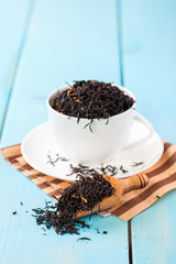 Tea leaves in a cup on a table. Selective focus. Copy space