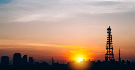 Oil refinery factory and logistic over sunrise Bangkok Thailand, with silhouette, Industrial zone, The equipment of oil refining, industrial pipelines of an oil-refinery plant, copy space.