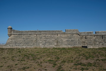 Fototapeta na wymiar Side view of Castillo de San Marcos in St Augustine, Florida, USA. Oldest fortress in America built in 1672 in Matanzas Bay Florida. Blue skies no clouds. Historic landmark.
