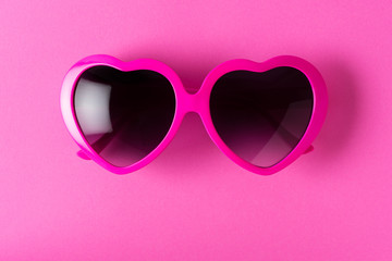 pink heart-shaped sunglasses isolated on pink background