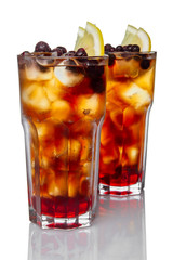 Two glasses with rum, ice, lemon and strawberry cocktail isolated on white