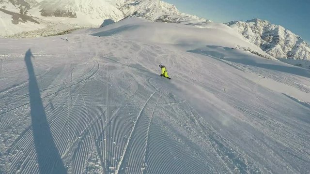 Fast ski ride behind snowboarder, POV