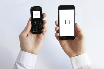 smart phone in hand on the background of working business environment