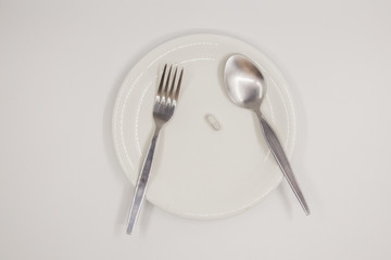 Capsule on white dish