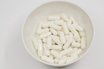 Capsule on white dish