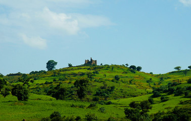 Fototapeta na wymiar Agriculture landscape with Guzara castle and fields of teff , Ethiopia