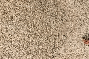Light plastered wall with crack for background. Close up detail. Toned
