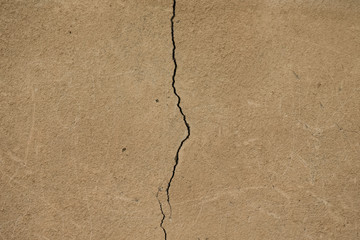 Light plastered wall with crack for background. Close up detail. Toned
